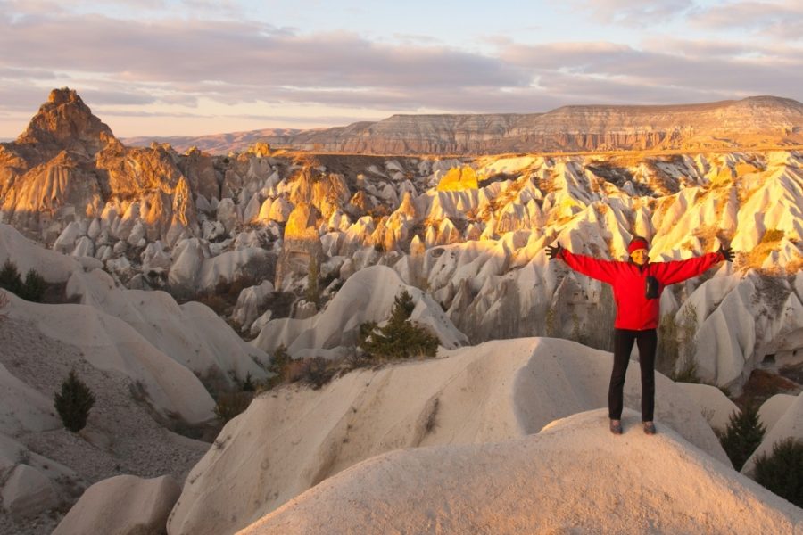 Hiker enjoying sunrise over Cappadocia valleys