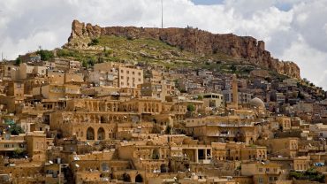 Ancient City of Mardin with layered stone houses and historic citadel in the background