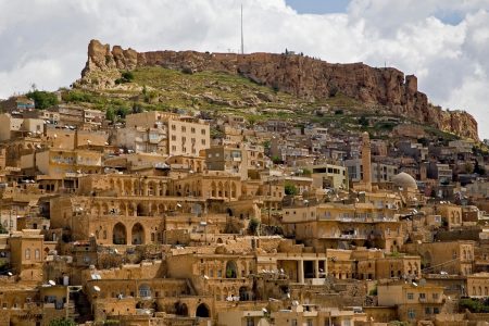 Ancient City of Mardin with layered stone houses and historic citadel in the background