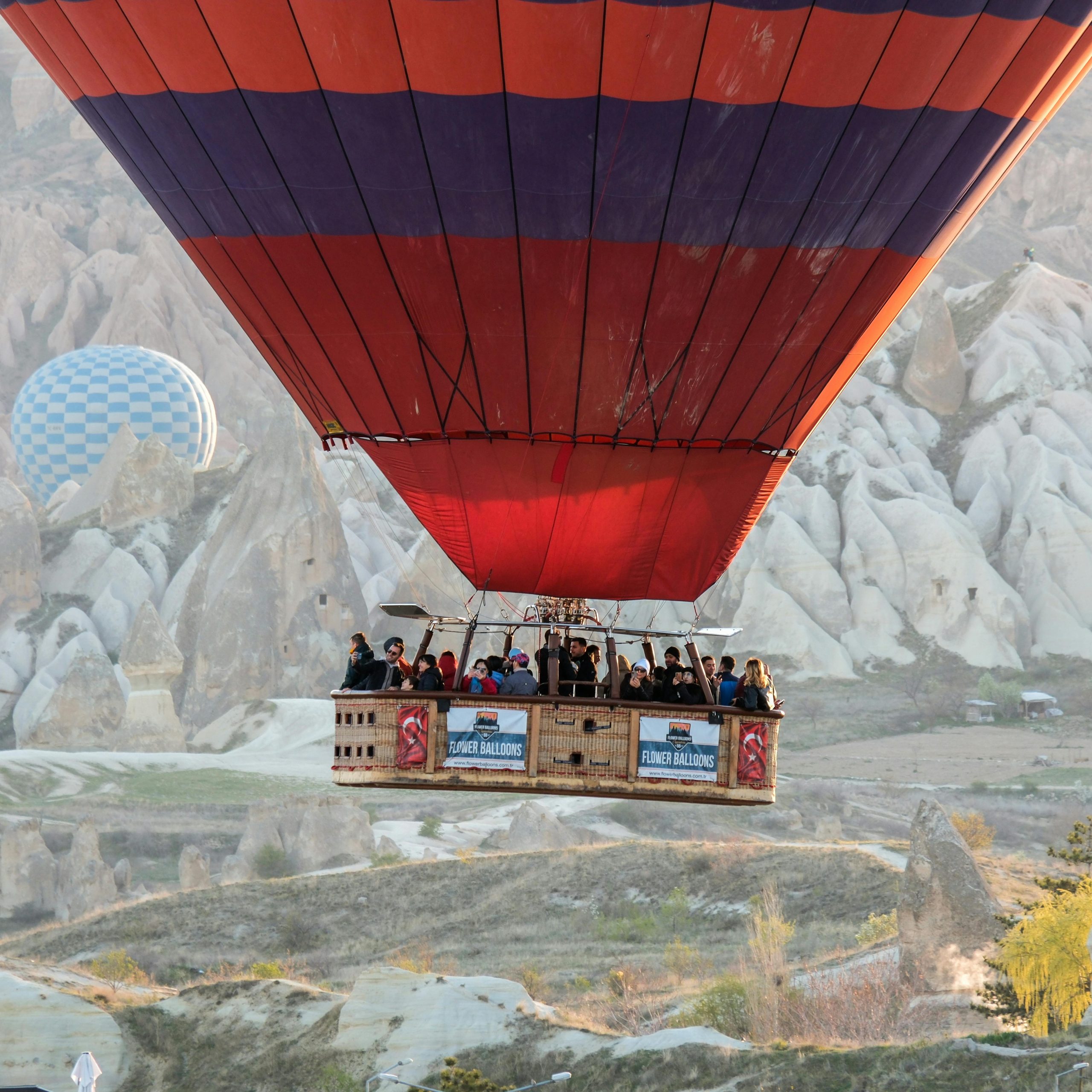 Balloon passengers mid-air above Cappadocia’s stone ridges