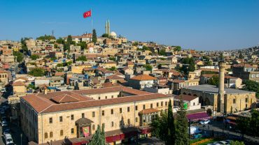 Panoramic view of Gaziantep’s old town with Turkish flag and mosque in the background