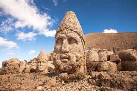 Stone statues on Mount Nemrut in Eastern Turkey under blue sky