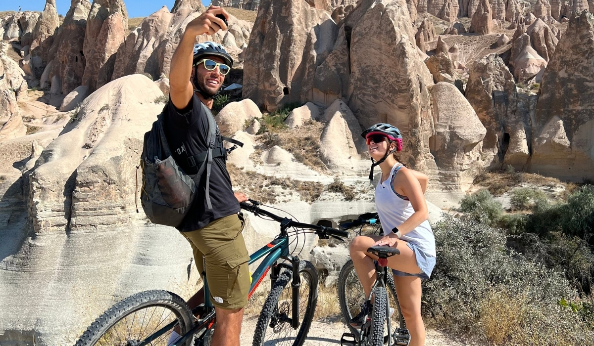 Bikers taking a selfie with fairy chimneys in Cappadocia