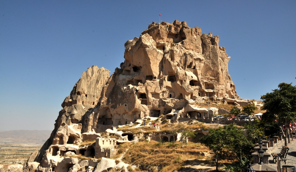 A view of Uçhisar Castle, the highest point in Cappadocia, showing its impressive rock-carved dwellings and tunnels. The fortress-like structure stands majestically above the valley, offering panoramic views and a glimpse into the region’s rich history.